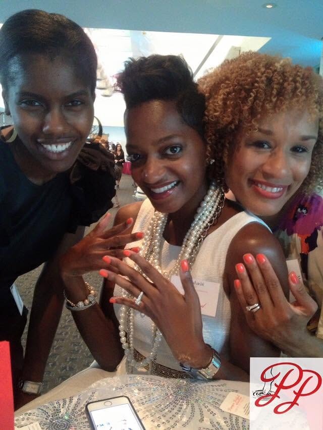 Guests showing fresh coral manicures at a Pamper Perfect event