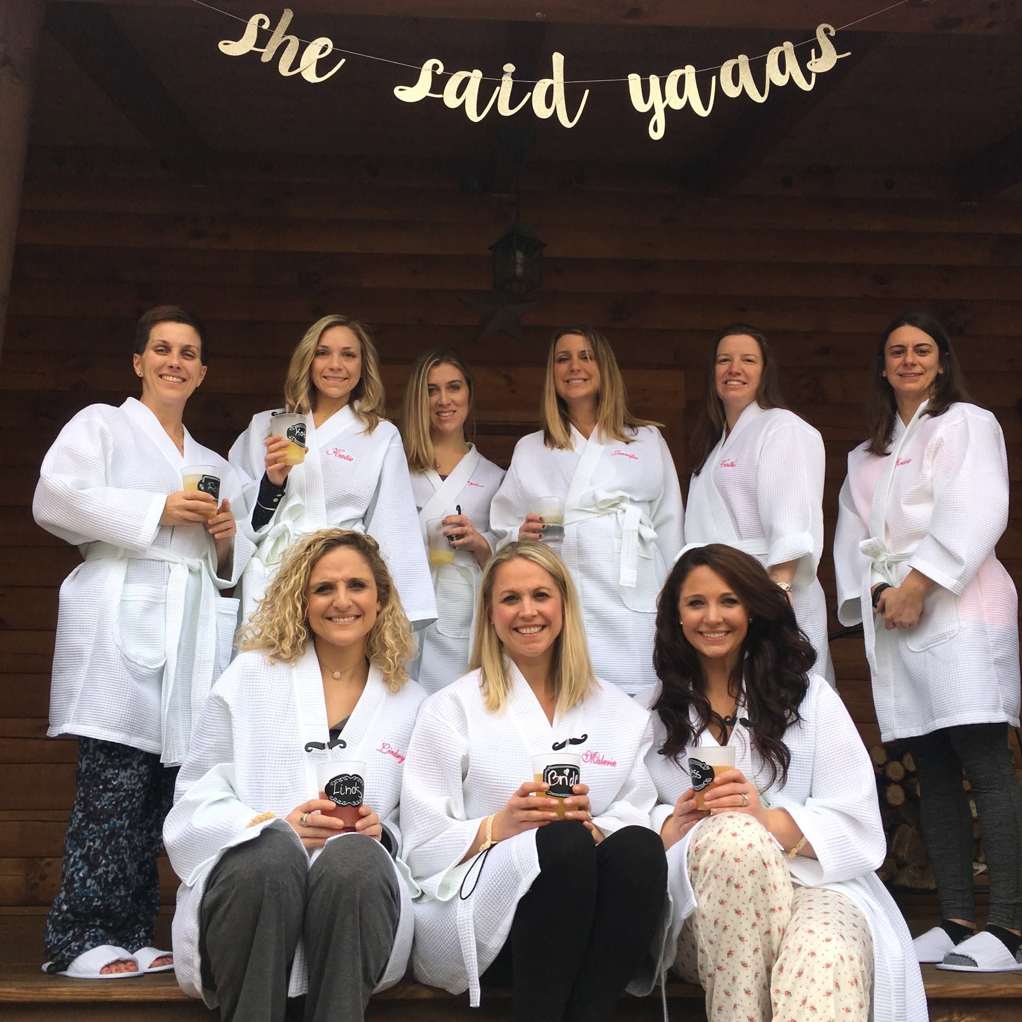 Friends in white robes at a Pamper Perfect celebration