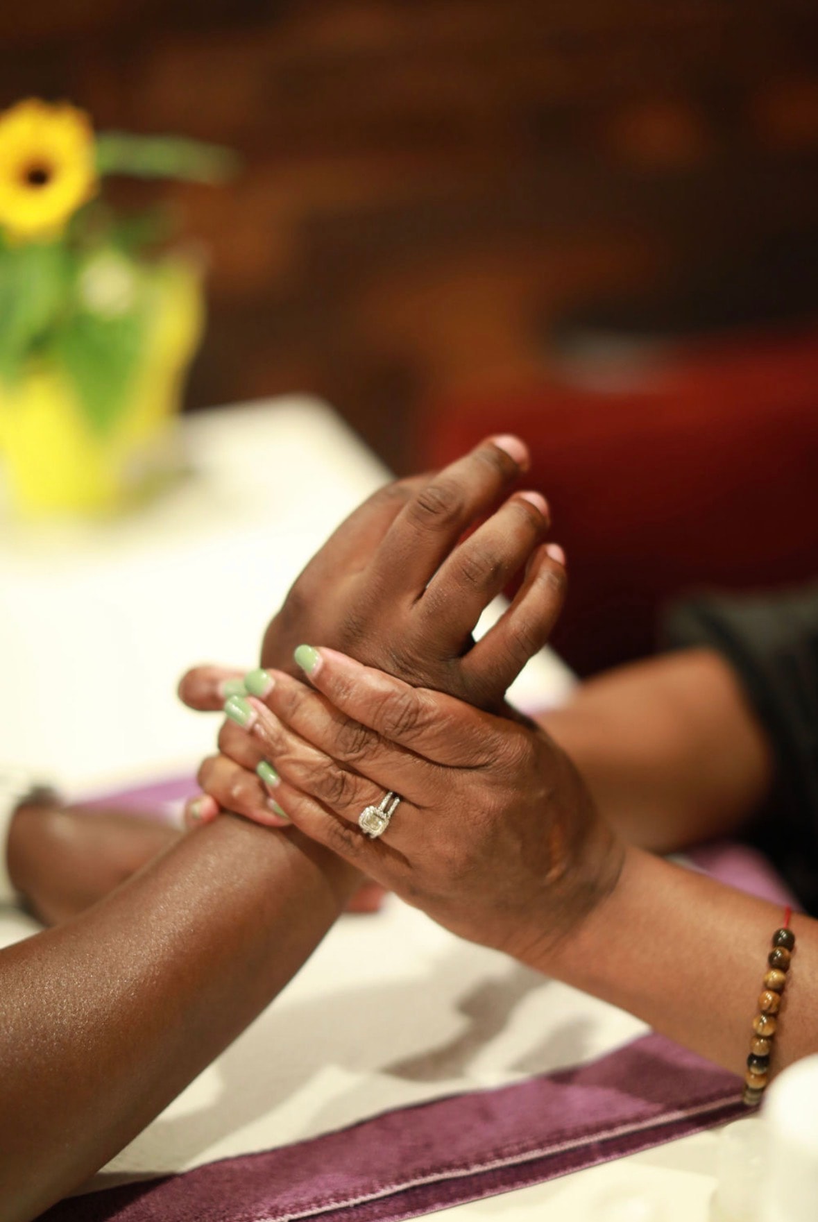 Professional hand massage with green manicure at a Pamper Perfect wellness experience